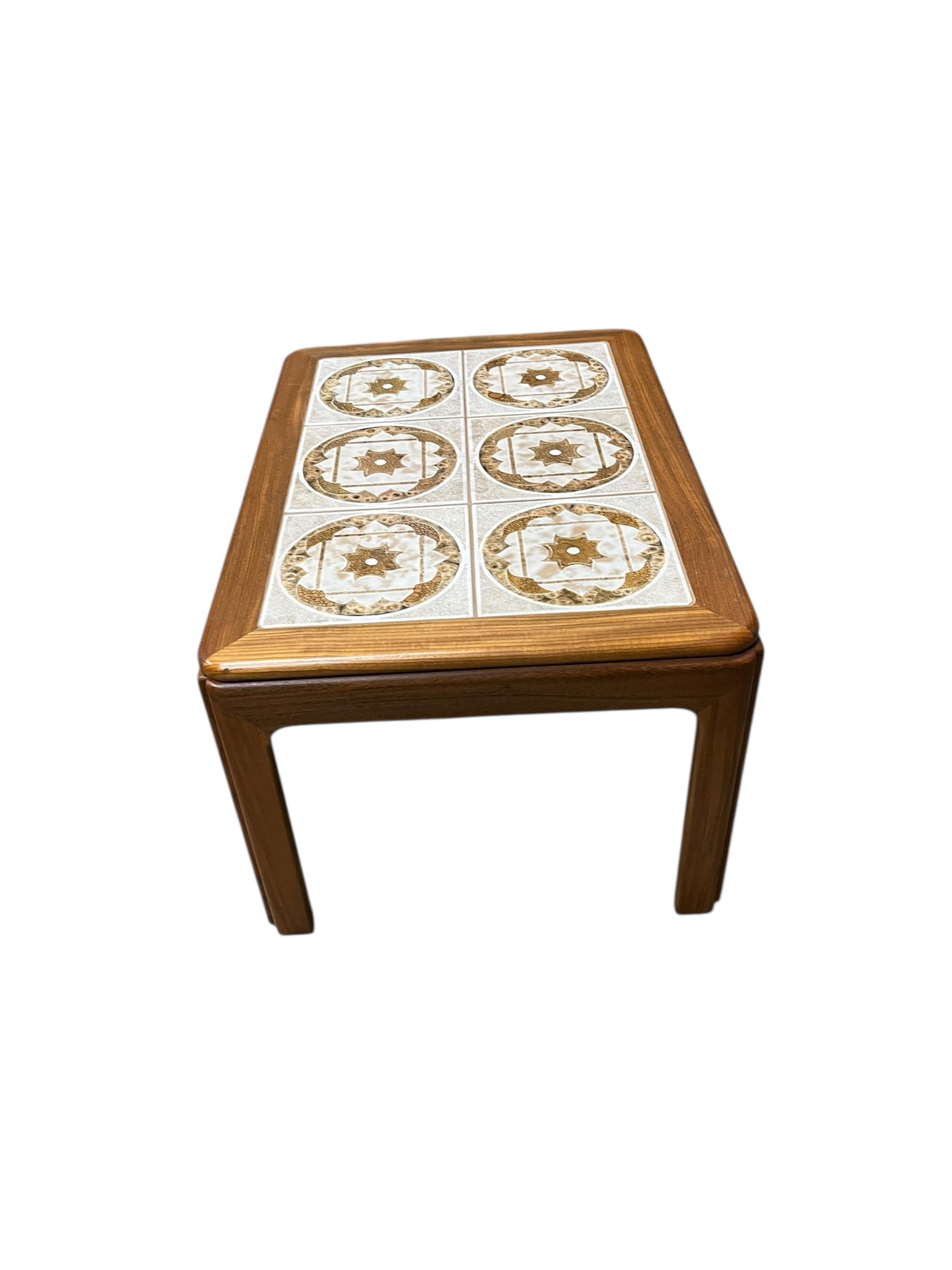 A mid century G Plan tile top teak coffee table and two matching occasional tables, larger width 134cm, depth 74cm, height 46cm